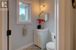 2 pc powder room off mudroom and side porch exit -