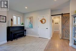Foyer leading to hallway with sliding barn door -
