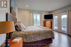 Primary bedrm with walk-out to elevated back deck -