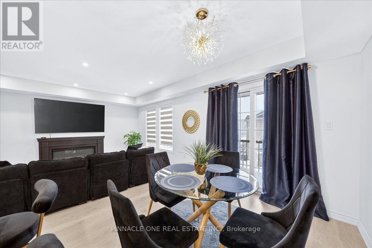 4 - 41 Pumpkin Corner Crescent, Barrie, ON - Indoor Photo Showing Dining Room With Fireplace