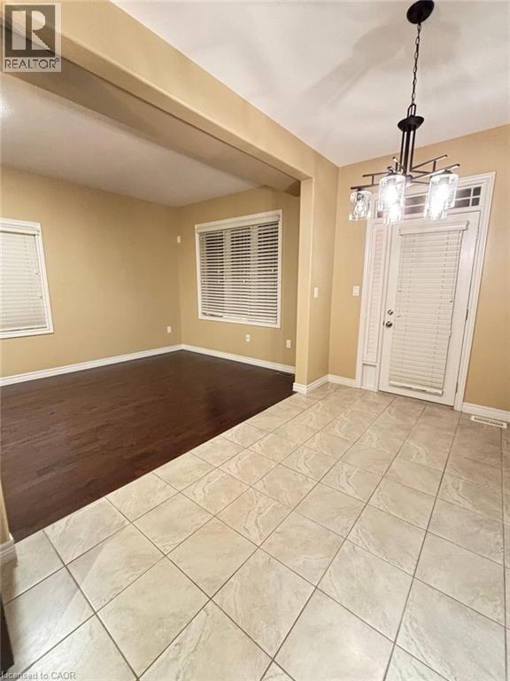 Entrance foyer featuring light tile patterned flooring and baseboards - 6 Chestnut Drive Unit# 16, Grimsby, ON - Indoor Photo Showing Other Room
