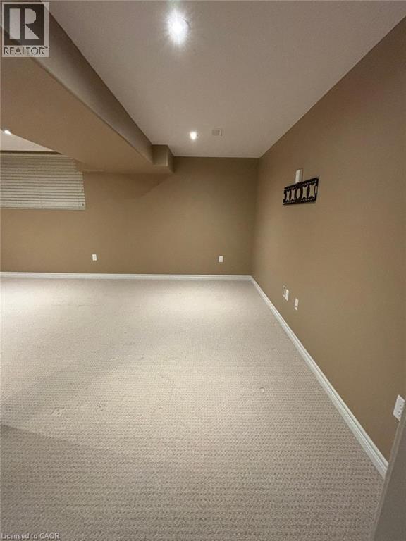 Finished basement featuring carpet flooring and baseboards - 6 Chestnut Drive Unit# 16, Grimsby, ON - Indoor Photo Showing Other Room