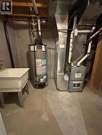 Utility room featuring gas water heater and heating unit -