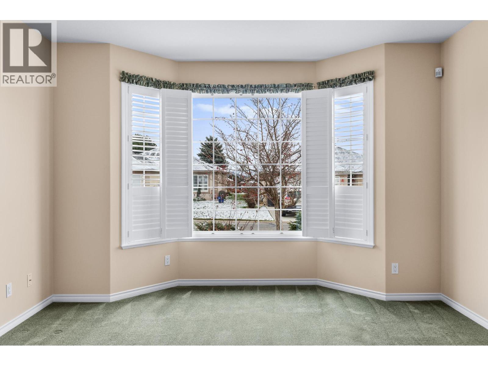 Bay window and california style shutters - 3360 Old Okanagan Highway Unit# 160, West Kelowna, BC - Indoor Photo Showing Other Room