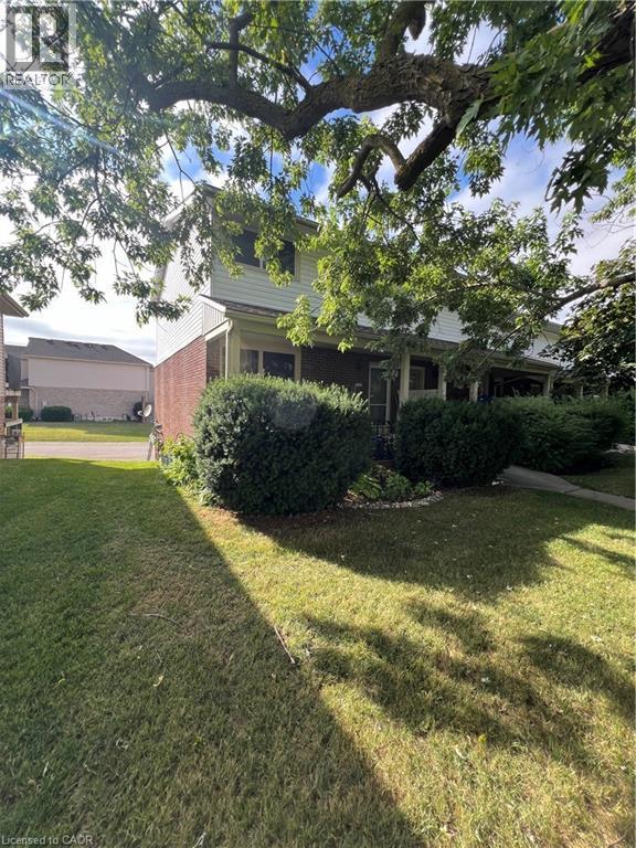 View of green lawn featuring a sunroom - 316 Dufferin Street, Stratford, ON - Outdoor