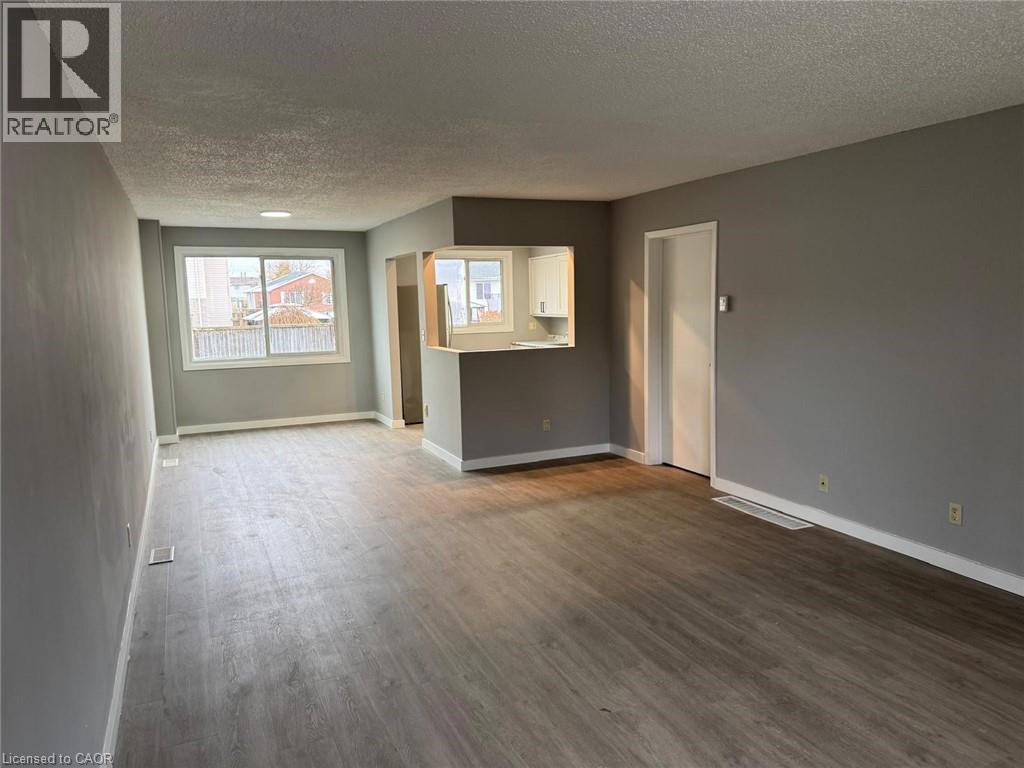 Unfurnished room with a textured ceiling and wood finished floors - 316 Dufferin Street, Stratford, ON - Indoor Photo Showing Other Room