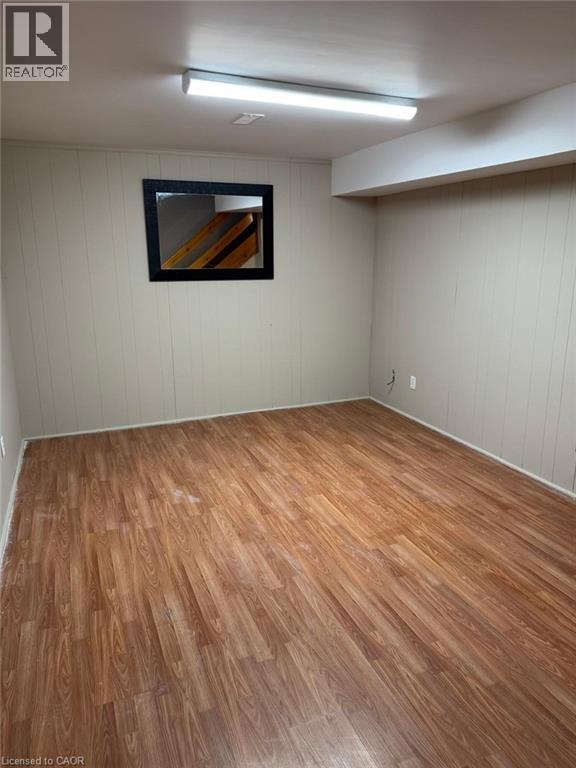 Spare room with light wood-style flooring and wood walls - 316 Dufferin Street, Stratford, ON - Indoor
