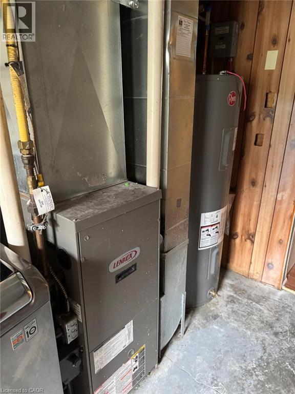 Utility room featuring heating unit and electric water heater - 316 Dufferin Street, Stratford, ON - Indoor Photo Showing Basement