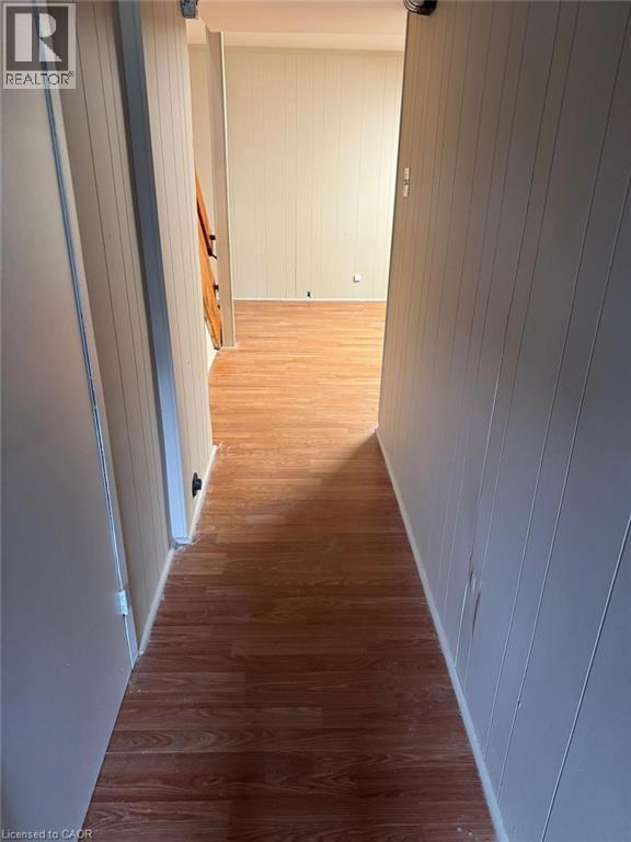 Corridor with wood walls and dark wood finished floors - 316 Dufferin Street, Stratford, ON - Indoor Photo Showing Other Room