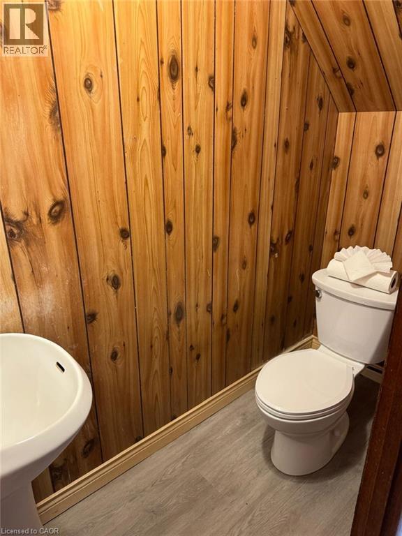Bathroom with wooden walls and wood finished floors - 316 Dufferin Street, Stratford, ON - Indoor Photo Showing Bathroom
