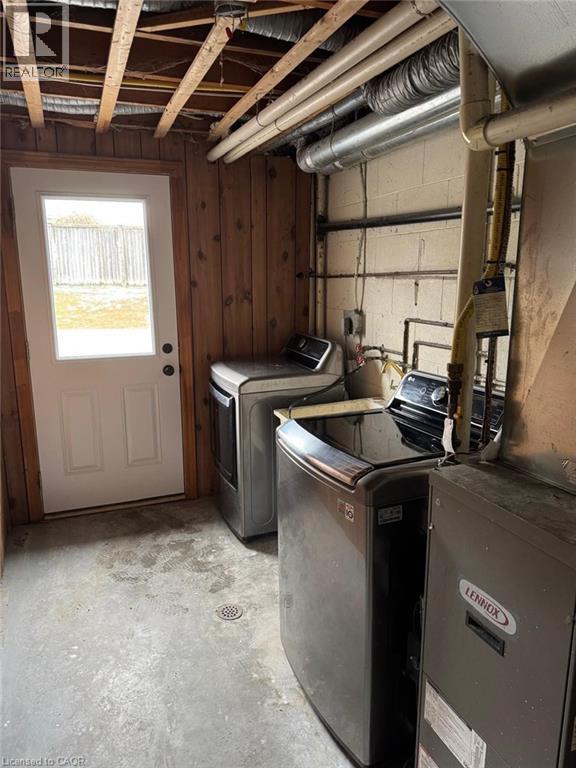 Laundry area with concrete flooring and washing machine and dryer - 316 Dufferin Street, Stratford, ON - Indoor Photo Showing Laundry Room