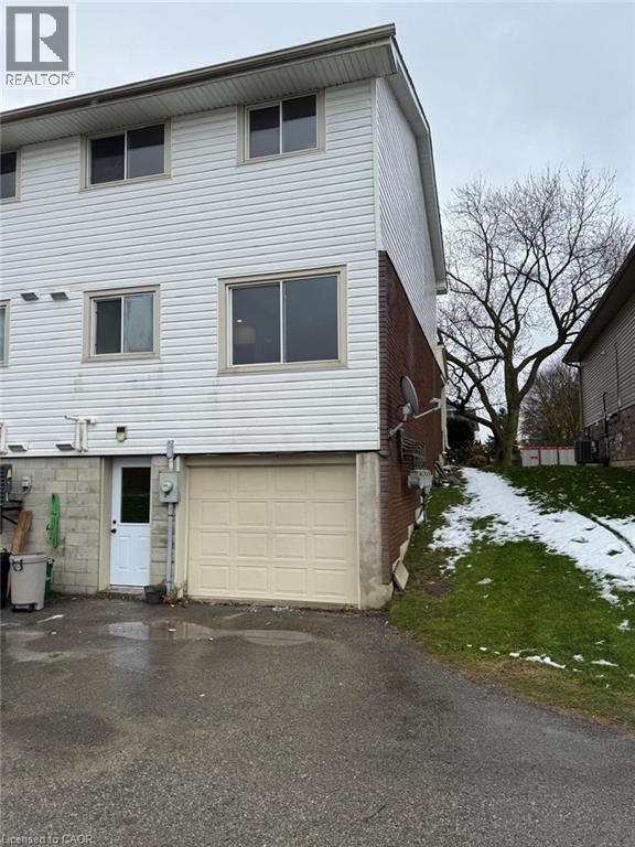 View of front of property featuring a garage and asphalt driveway - 316 Dufferin Street, Stratford, ON - Outdoor With Exterior
