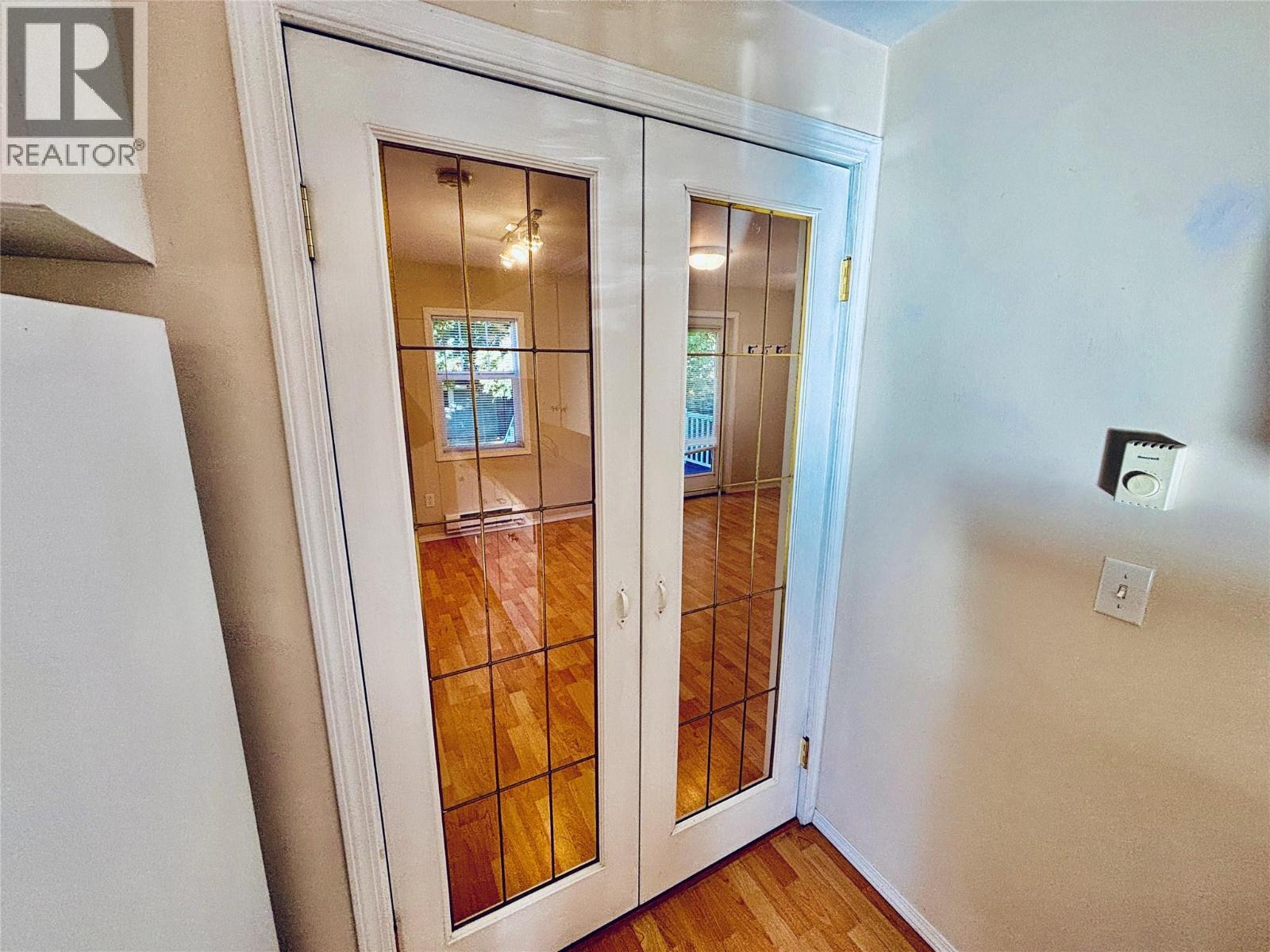 French Doors between Kitchen/LR - 501 Arthur Street, Slocan, BC - Indoor Photo Showing Other Room