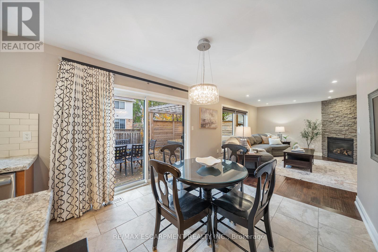 1351 Mcguffin Gate, Milton, ON - Indoor Photo Showing Dining Room With Fireplace