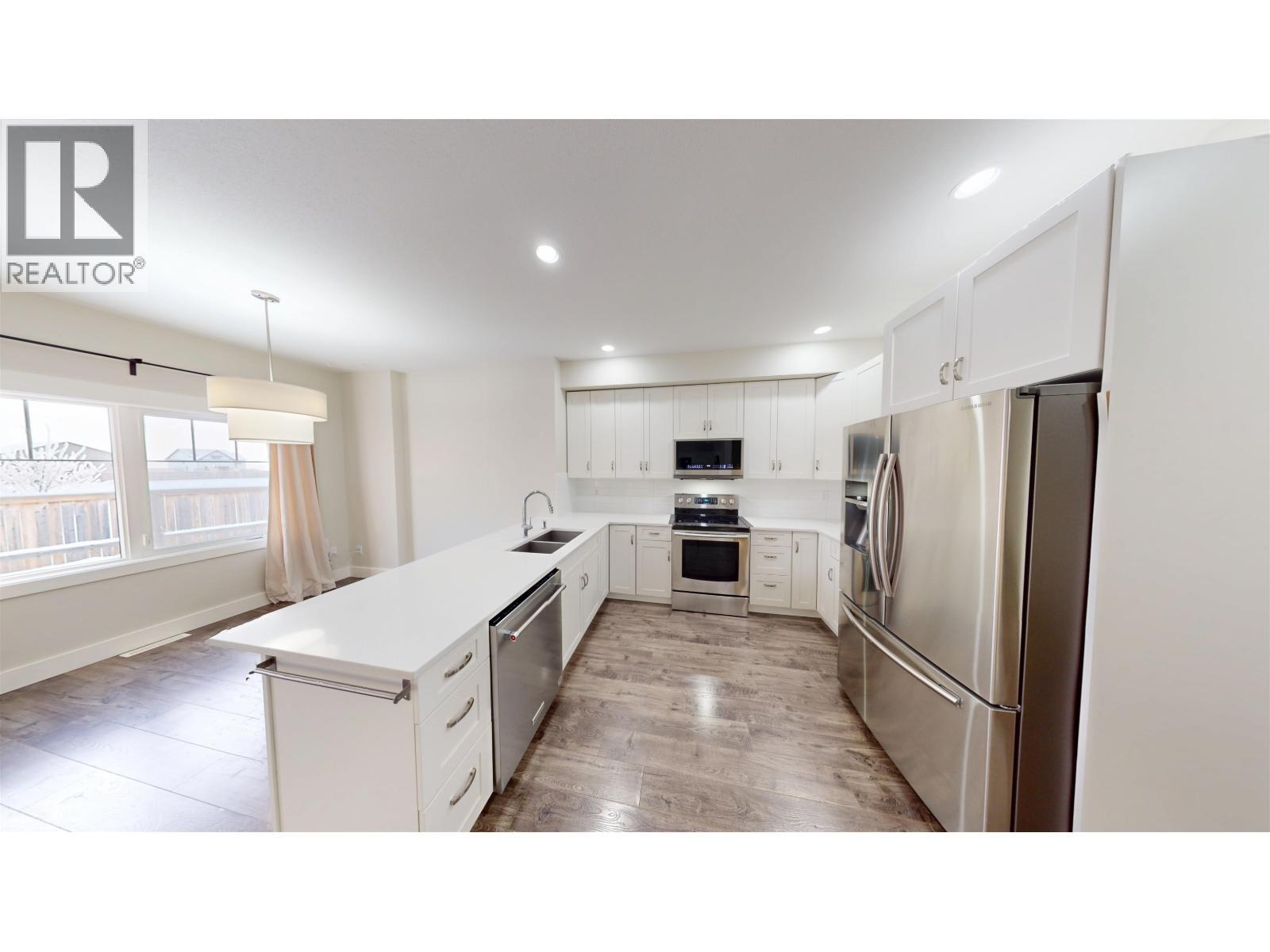 8207 81A Street, Fort St. John, BC - Indoor Photo Showing Kitchen With Double Sink