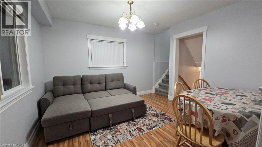 Bedroom featuring a chandelier and wood finished floors - 10 Doll Court, Kitchener, ON - Indoor