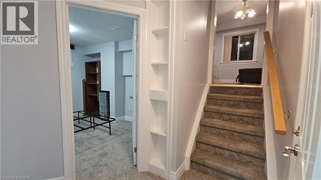 Staircase with carpet flooring and built in features - 10 Doll Court, Kitchener, ON - Indoor Photo Showing Other Room