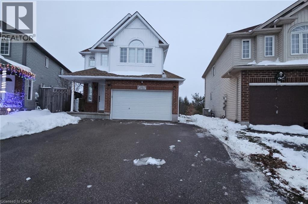 Traditional home featuring brick siding, an attached garage, and asphalt driveway - 10 Doll Court, Kitchener, ON - Outdoor