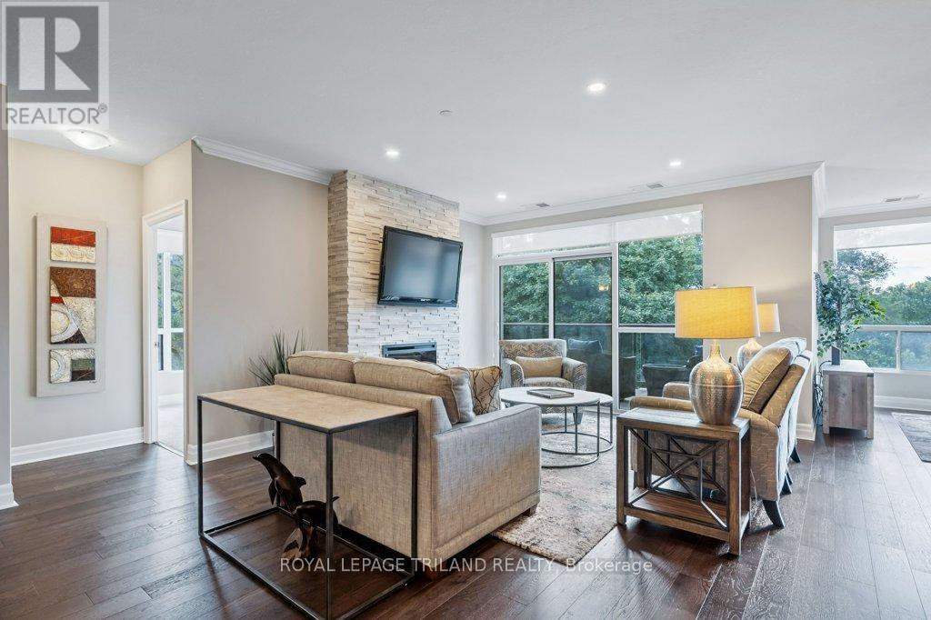504 - 1200 Commissioners Road W, London South (South B), ON - Indoor Photo Showing Living Room With Fireplace