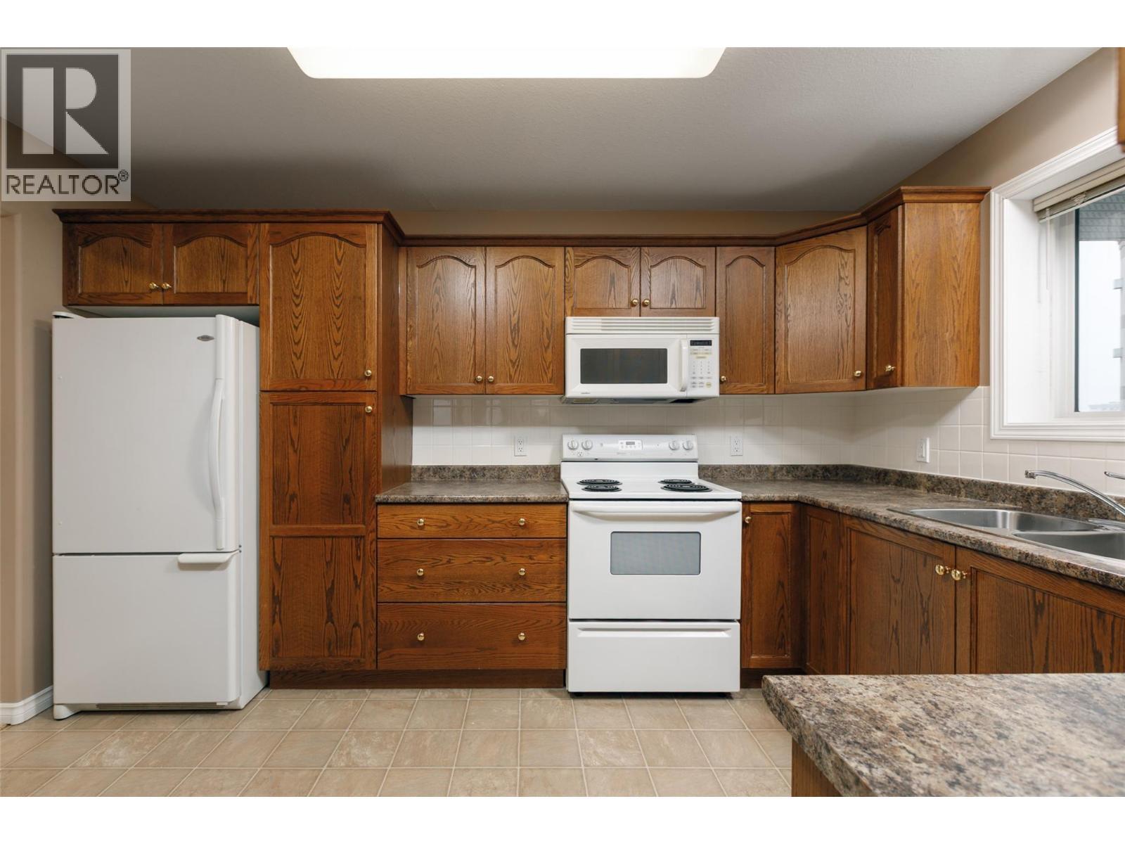 1966 Durnin Road Unit# 501, Kelowna, BC - Indoor Photo Showing Kitchen With Double Sink