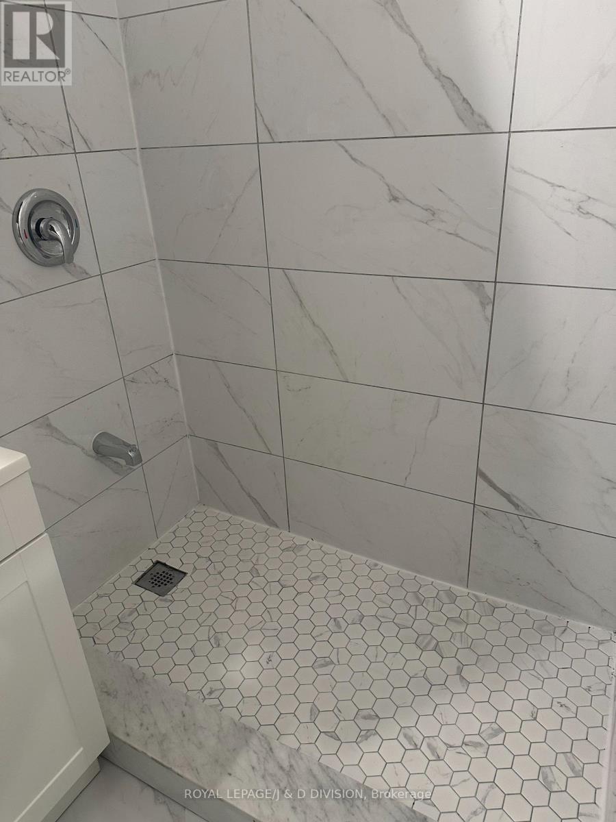 Hex tiled shower - 201 - 325 Sammon Avenue, Toronto, ON - Indoor Photo Showing Bathroom