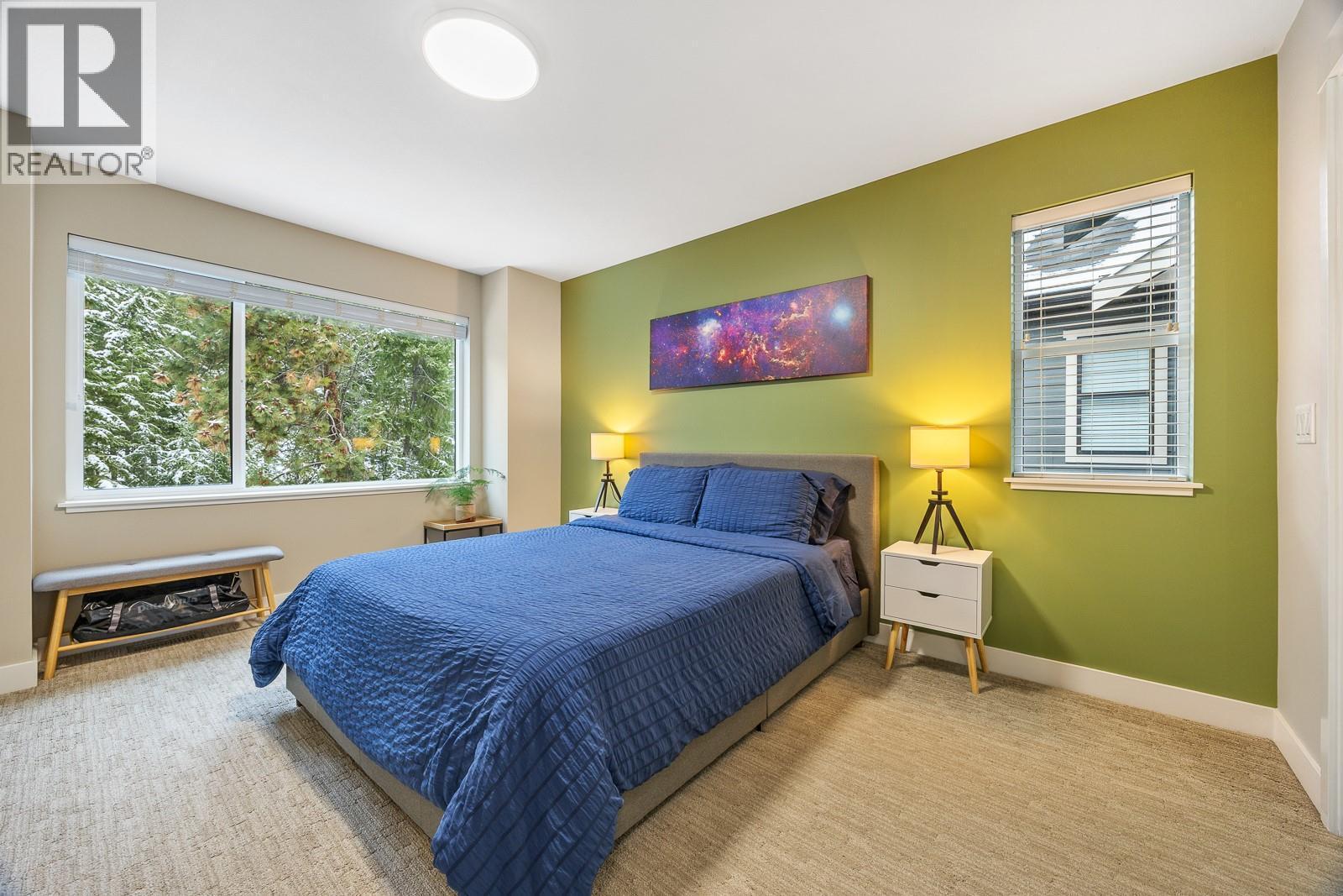 Bright primary suite with a walk-in closet and lots of natural light. - 2490 Tuscany Drive Unit# 54, West Kelowna, BC - Indoor Photo Showing Bedroom