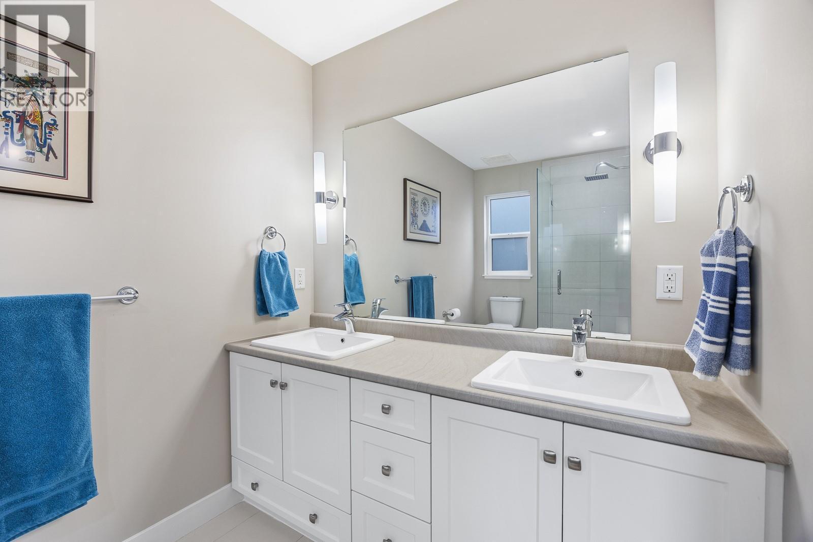 Beautiful ensuite with his and her sinks and a walk-in shower. - 2490 Tuscany Drive Unit# 54, West Kelowna, BC - Indoor Photo Showing Bathroom