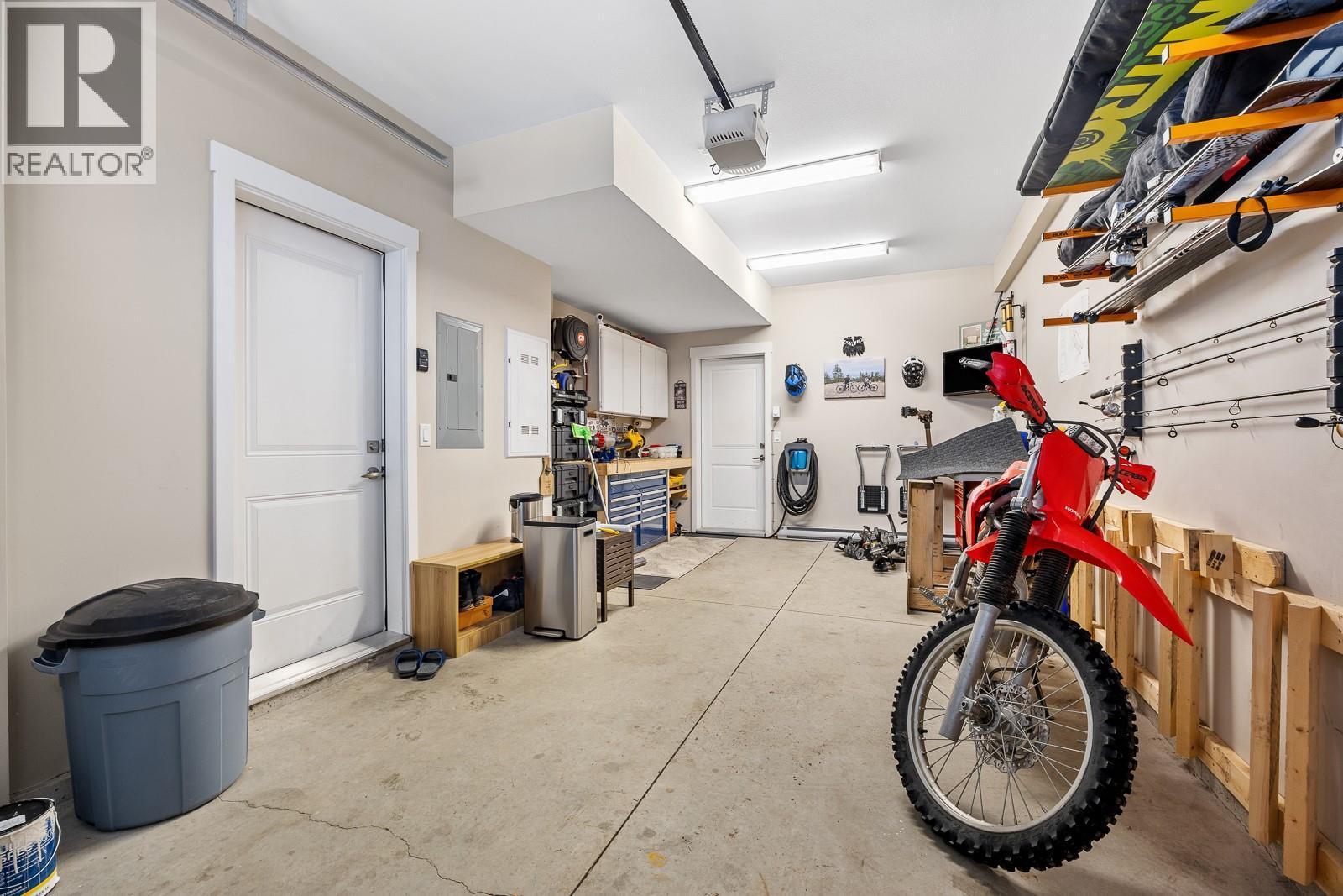 One-car garage with baseboard heating and extra storage for all your gear. - 2490 Tuscany Drive Unit# 54, West Kelowna, BC - Indoor Photo Showing Garage