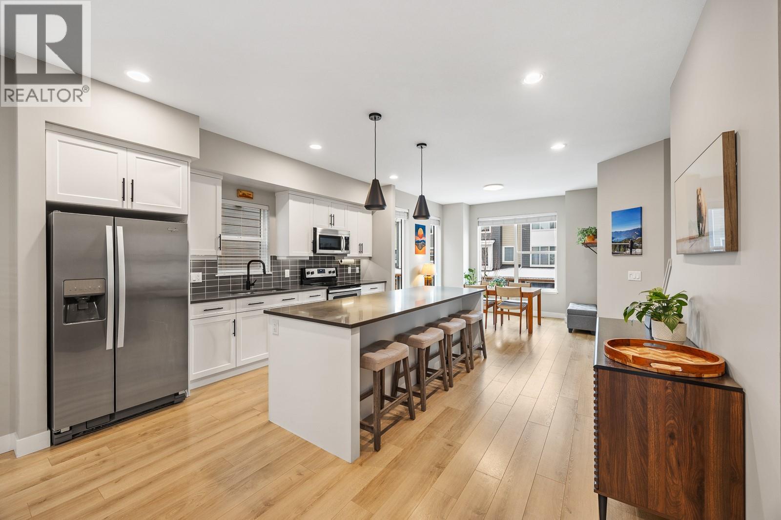 Large kitchen island, loads of counter space, and a Whirlpool appliance package, perfect for entertaining. - 2490 Tuscany Drive Unit# 54, West Kelowna, BC - Indoor Photo Showing Kitchen With Upgraded Kitchen