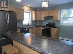 Newer kitchen with brushed GE appliances. -