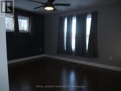 Primary bedroom with two windows. -