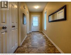 Doorway with baseboards and stone finish flooring -