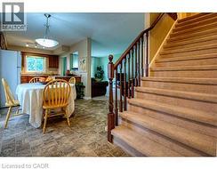 Dining space with stairs and stone finish floors -