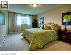 Bedroom featuring light colored carpet -
