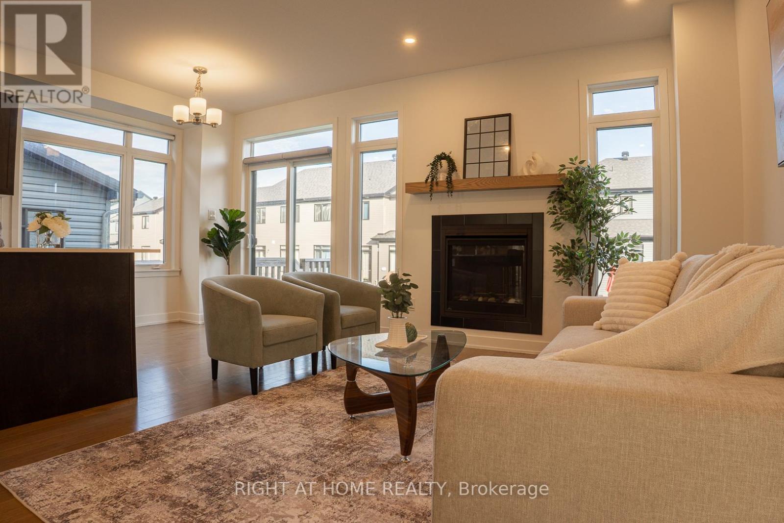 Bright Living Room with Nat Gas Fireplace - 16 Nettle Crescent, Ottawa, ON - Indoor Photo Showing Living Room With Fireplace