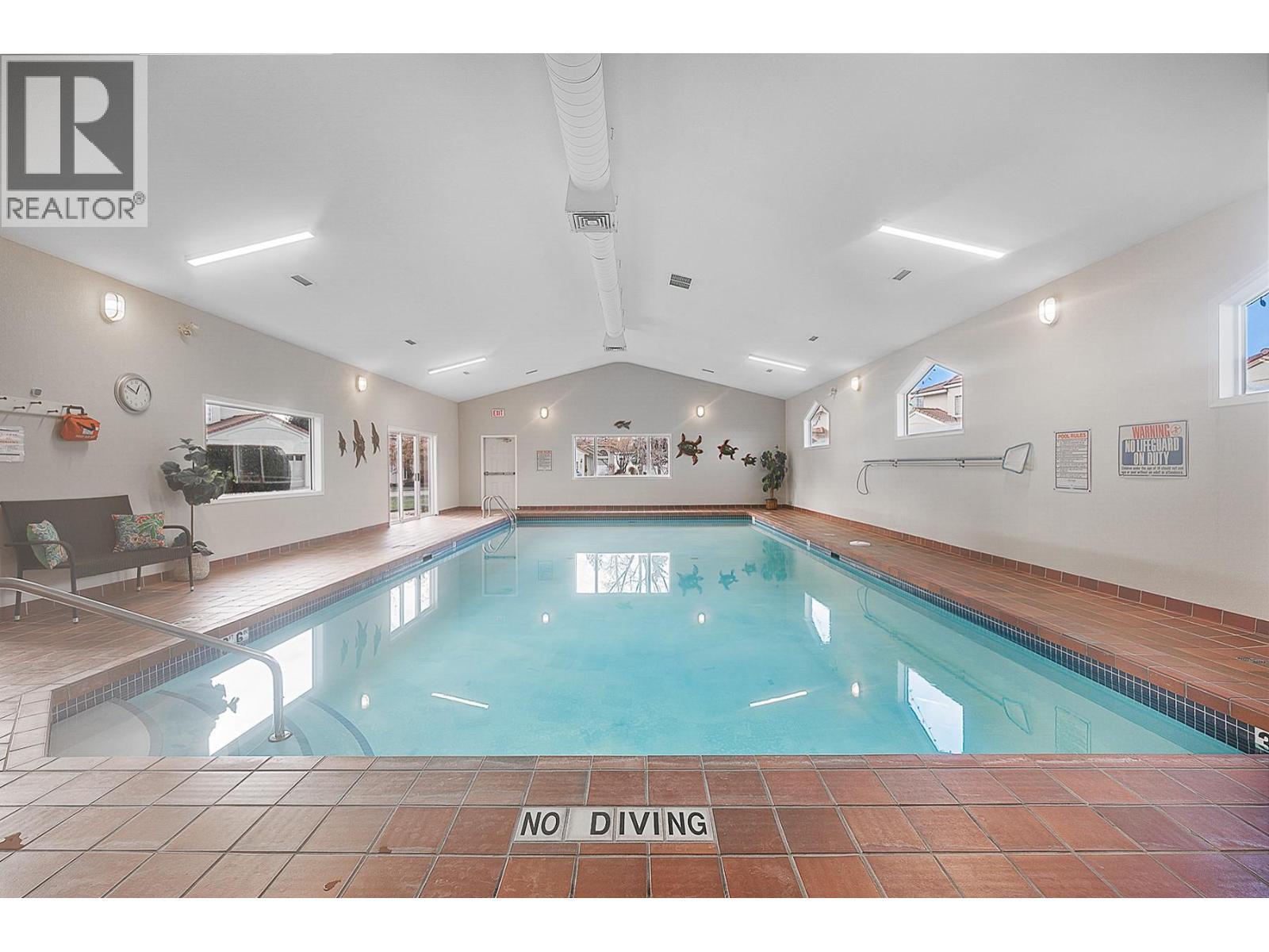 609 Truswell Road Unit# 105, Kelowna, BC - Indoor Photo Showing Other Room With In Ground Pool