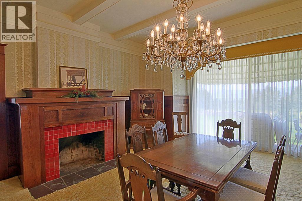 2990 Dunster Road, Kelowna, BC - Indoor Photo Showing Dining Room With Fireplace