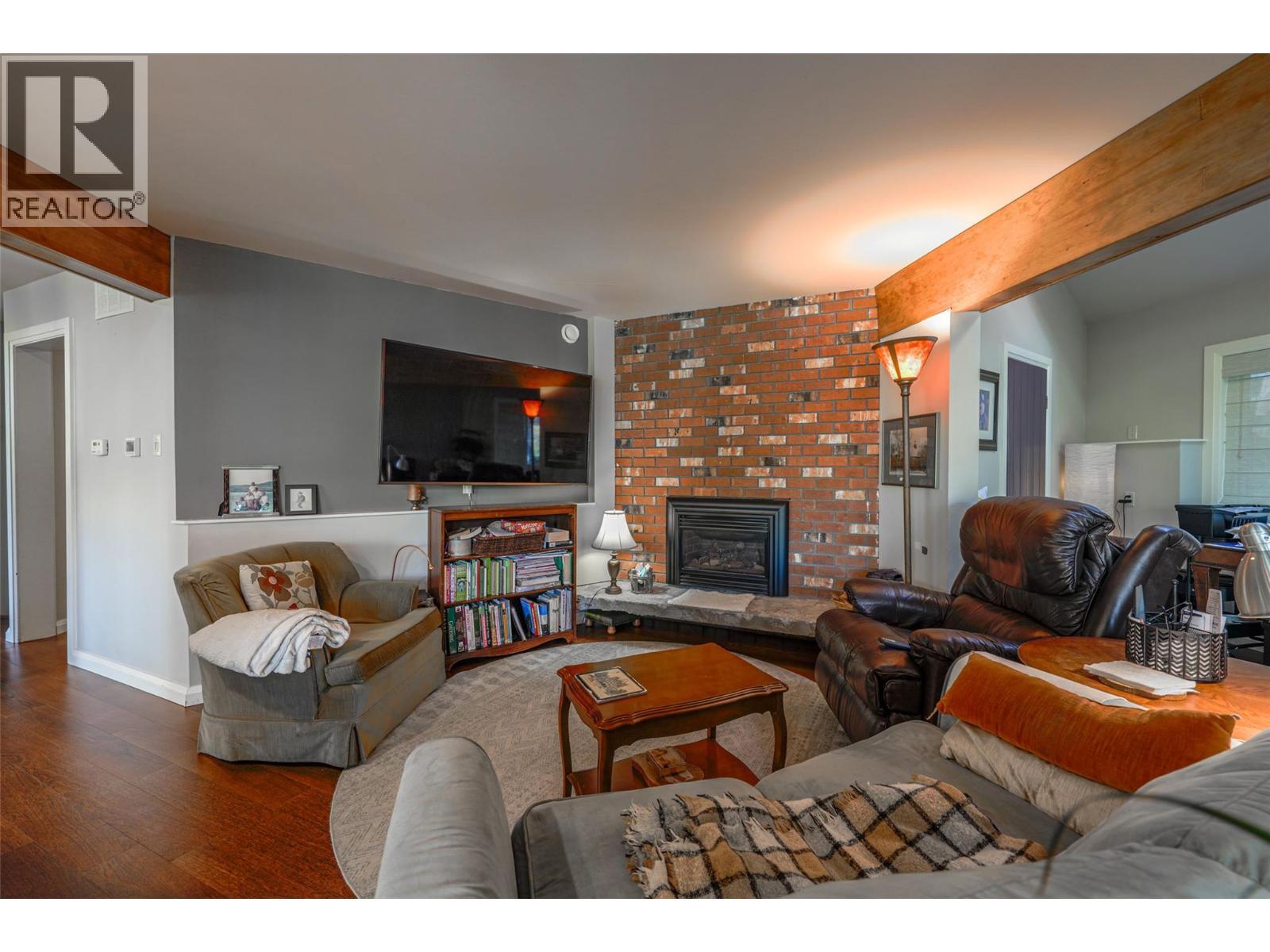 Sitting area off Kitchen with gas Fireplace - 14038 Ponderosa Way, Coldstream, BC - Indoor Photo Showing Living Room With Fireplace