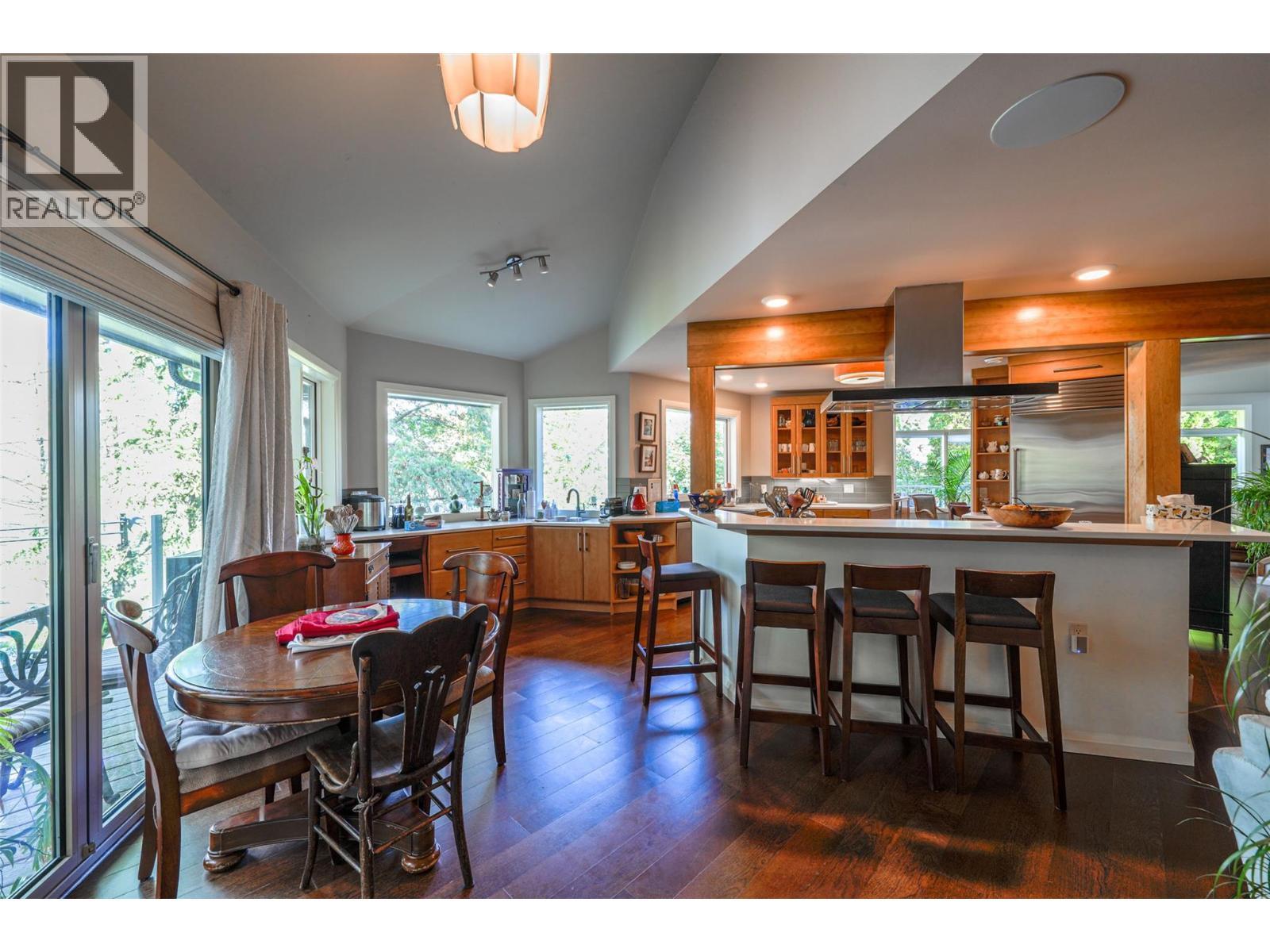 Kitchen eating area with sliding doors to Deck - 14038 Ponderosa Way, Coldstream, BC - Indoor Photo Showing Dining Room