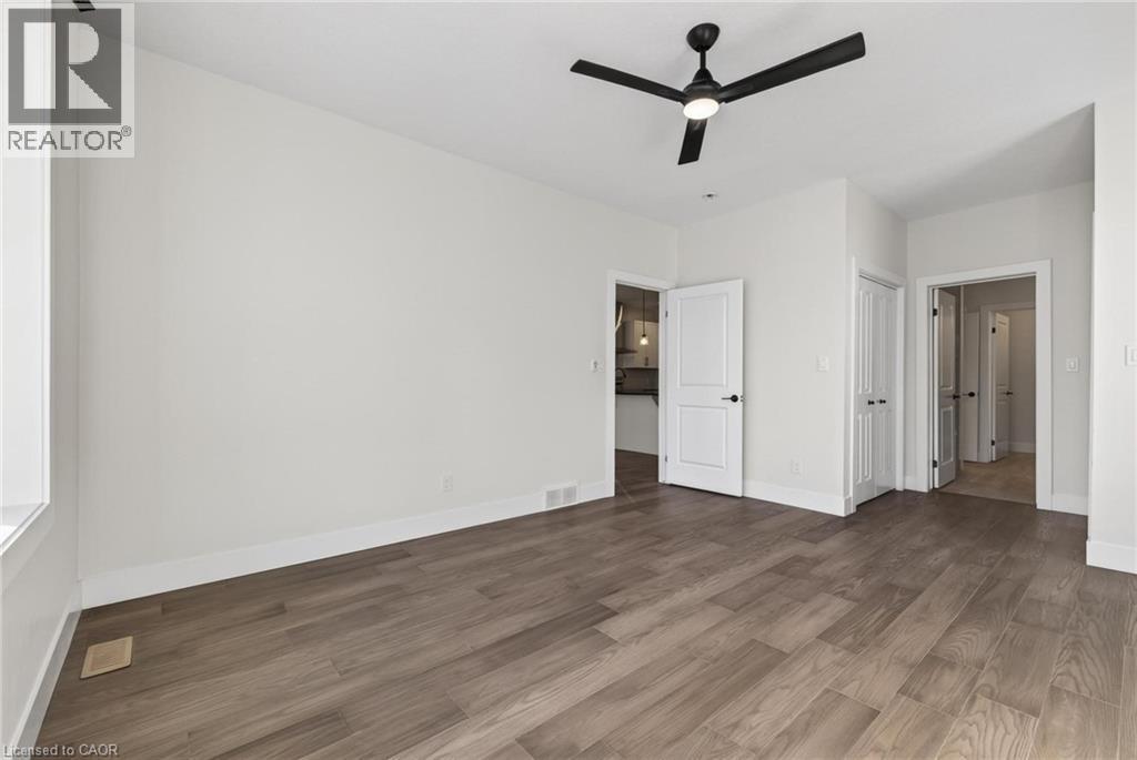 Unfurnished bedroom featuring wood finished floors and a ceiling fan - 7 South Court Street W, Norwich, ON - Indoor Photo Showing Other Room