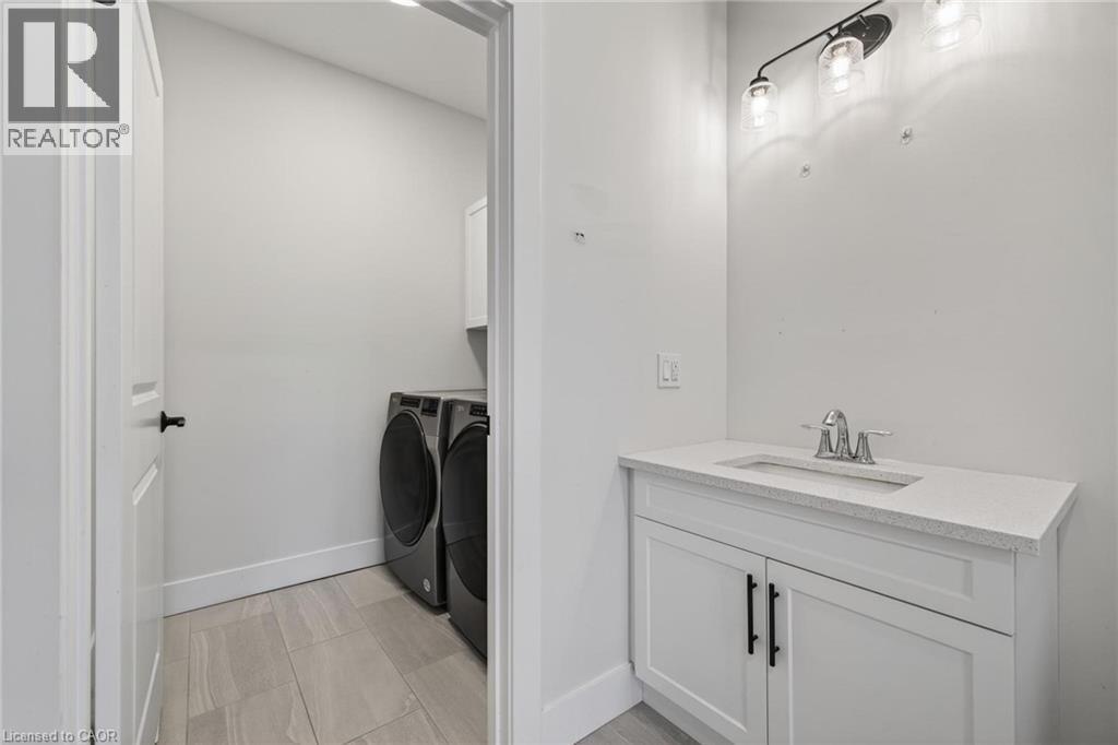 Bathroom featuring vanity and separate washer and dryer - 7 South Court Street W, Norwich, ON - Indoor Photo Showing Laundry Room