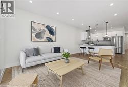 Living area featuring light wood-style flooring and recessed lighting -