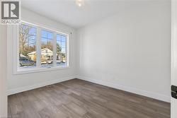 Empty room featuring wood finished floors and baseboards -