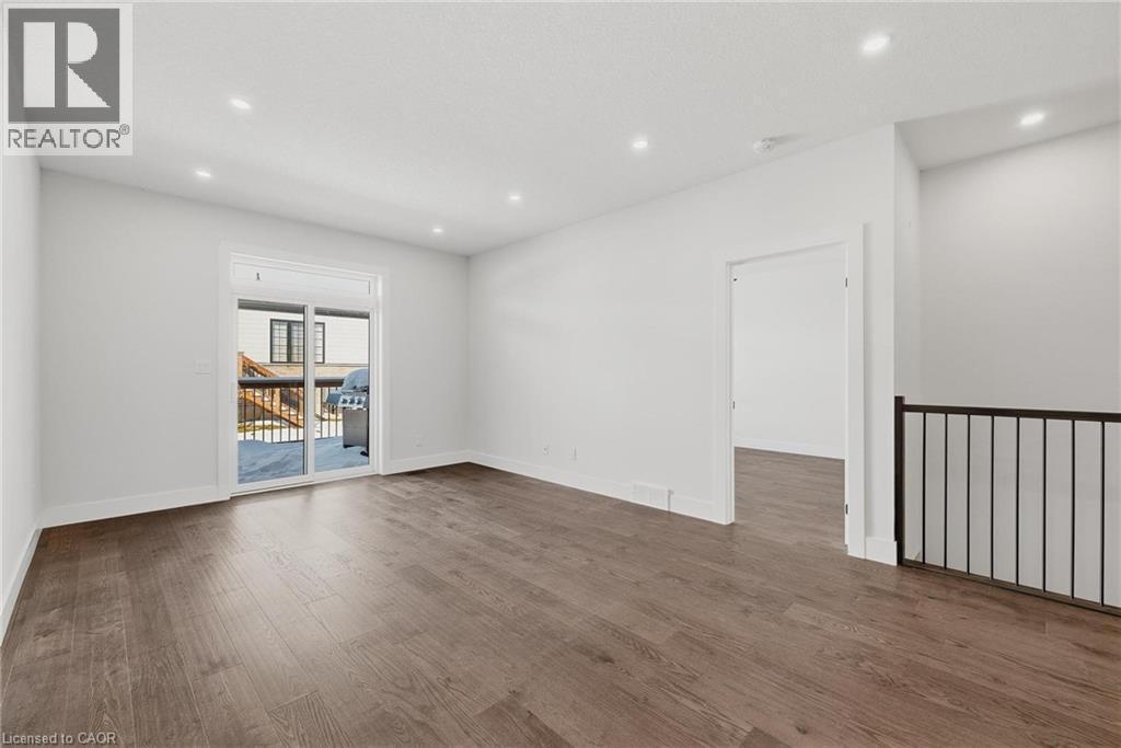 Spare room featuring dark wood-type flooring and recessed lighting - 4 Elgin Street W, Norwich, ON - Indoor Photo Showing Other Room