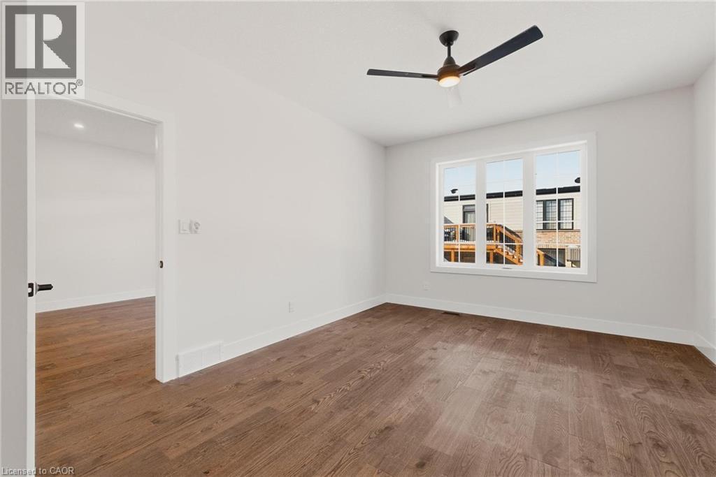 Spare room featuring dark wood-style floors and ceiling fan - 4 Elgin Street W, Norwich, ON - Indoor Photo Showing Other Room