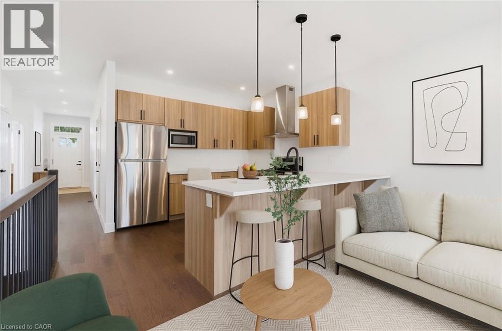 Living room with dark wood finished floors and recessed lighting - 4 Elgin Street W, Norwich, ON - Indoor Photo Showing Kitchen With Stainless Steel Kitchen