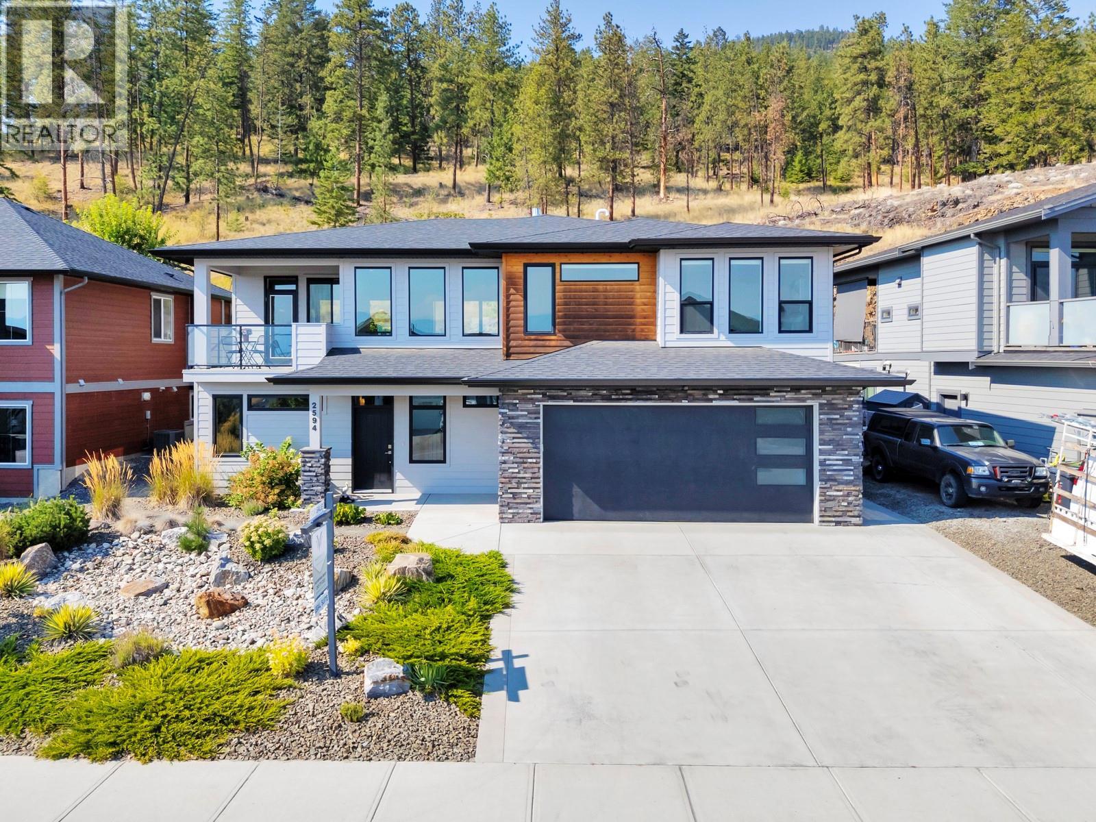 Backing onto green space with trees amongst your property line - 2594 Crown Crest Drive, West Kelowna, BC - Outdoor With Facade