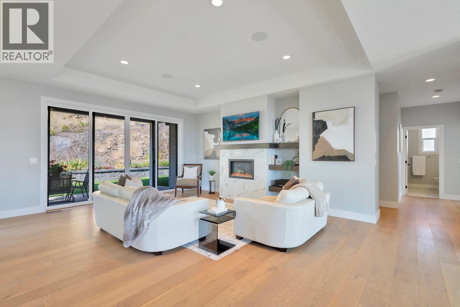 Interior & exterior speakers installed throughout the home - 2594 Crown Crest Drive, West Kelowna, BC - Indoor Photo Showing Living Room With Fireplace