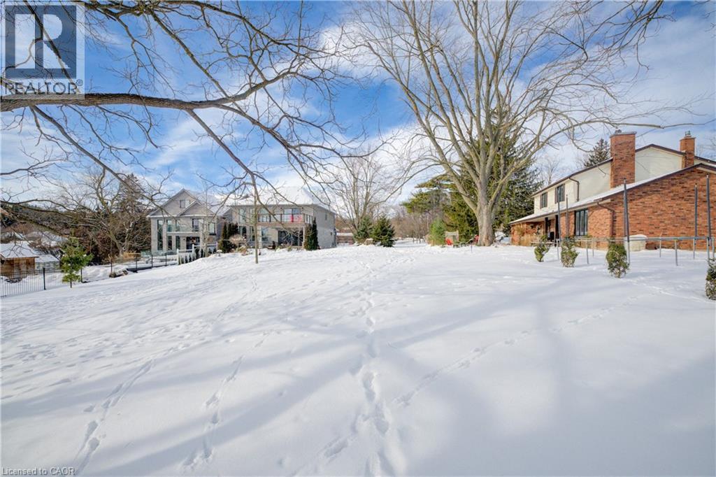 View of yard covered in snow - 54 Roos Street, Kitchener, ON