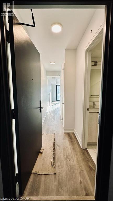 Corridor with light wood-style floors and baseboards - 1 Jarvis Street Unit# 509, Hamilton, ON - Indoor Photo Showing Other Room